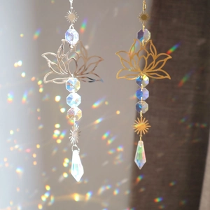 Lotus suncatcher with metal flower and faceted crystal prism producing rainbow light