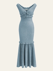 Close-up detail of blue knit fabric texture and Cider brand label on a backless dress