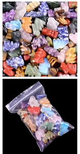 Close-up of assorted natural crystal and agate mini rabbit figurines in bulk packaging