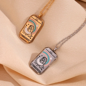 Detail of gold and silver tarot necklaces featuring L'Imperatrice design on silk
