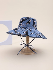 Close-up of blue floral print sun hat with wide brim and adjustable chin strap