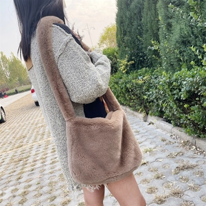 Detail view of brown faux fur tote bag with wide plush strap for autumn and winter outfits