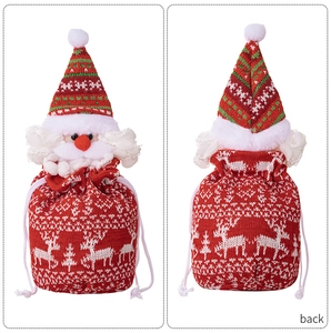Detail of knitted Santa Claus drawstring gift bag with reindeer pattern and 3D nose