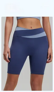 Detail of high-waist crossover waistband on navy blue elastic yoga fitness shorts