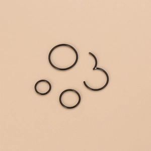 Set of five black stainless steel seamless hoop rings and hinged segment rings for piercing