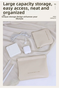 Macro shot of cream leather storage pouches in two sizes on soft satin fabric texture