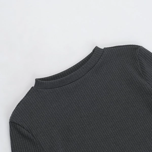 Close-up of dark grey ribbed knit fabric showing neckline and shoulder texture detail