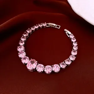 Pink zircon heart-shaped teardrop bracelet in silver finish on red silk background