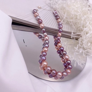 Detailed view of large baroque freshwater pearls with purple gradient and metallic luster