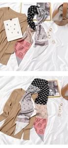 Detail of colorful paisley silk scarf styled with a brown bag and knit sweater