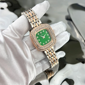 Detail showing the green square dial and diamond-set bezel of a vintage women watch