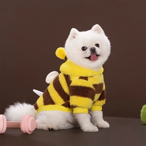 Detail of plush bee-themed dog hoodie featuring soft yellow stripes and small white wings