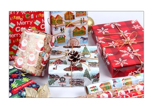 Detail view of gift boxes wrapped in festive Christmas paper with reindeer and snowflake patterns