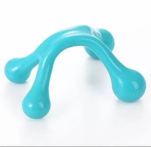 Detail of teal plastic 4-point manual massager with ergonomic handle for body muscle relief