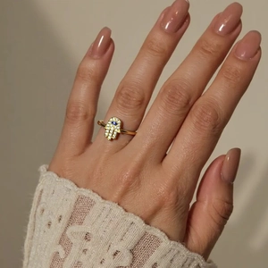 Gold Hamsa Hand ring with evil eye and zircons on finger, elegant boho jewelry style