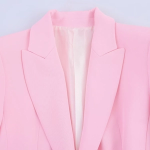 Close-up of pink blazer notched lapel detail with high-quality woven fabric texture