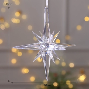 Detailed view of a 16cm clear acrylic star ornament with festive bokeh background