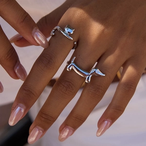 Detailed view of silver cat and dachshund dog adjustable rings on model fingers