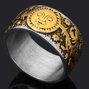 Detailed macro view of the vintage Thor's hammer skull ring with gold sun face relief