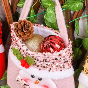 Pink sequin Christmas gift bag with snowman embroidery and festive pinecone decorations
