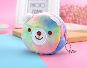 Close-up of tie-dye plush bear coin purse with embroidered details and metal chain