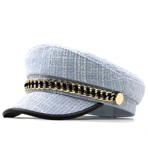 Light blue tweed baker boy hat with gold chain detail and black leather brim