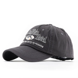 Detail of Dolphin Hotel 3D embroidery on washed charcoal cotton baseball cap