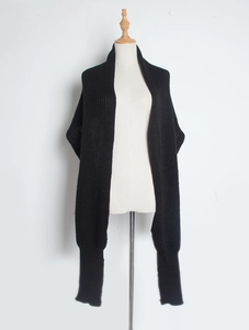 Detail of black chunky knit scarf showing ribbed texture and thick acrylic yarn
