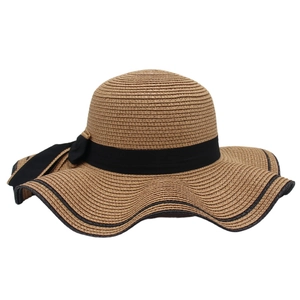 Detail of wide brim straw hat with woven texture and black ribbon bow accent