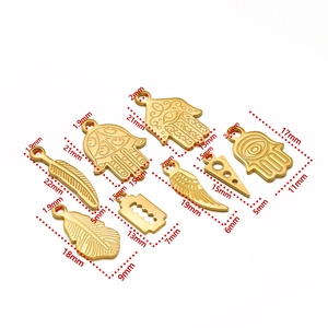 Detailed size chart for gold stainless steel charms including Hamsa hand and feathers