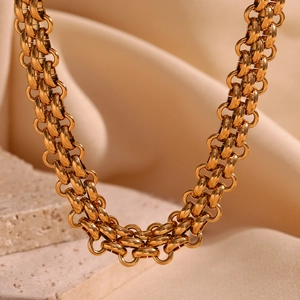 Detailed close-up of 18K gold plated multi-link chain with polished metal texture
