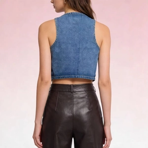 Slim fit denim vest for women paired with brown leather pants seen from back view