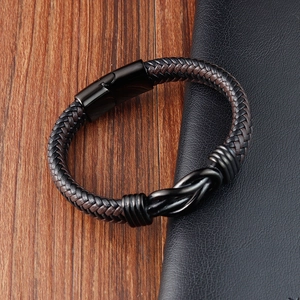 Men's leather infinity bracelet with black metal clasp on rustic wooden surface