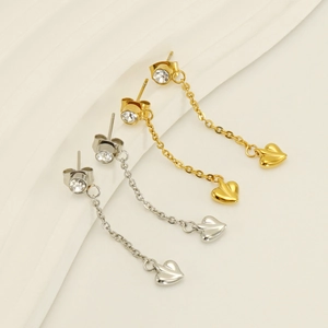 Detail of gold and silver heart tassel earrings with sparkling rhinestones and chains