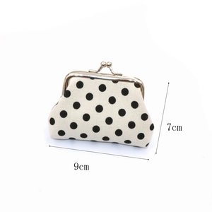 Polka dot canvas coin purse with metal clasp measuring nine by seven centimeters