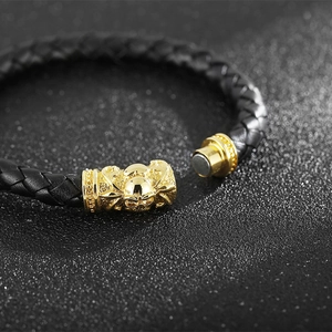 Braided black leather bracelet for men with golden skull magnetic clasp closure