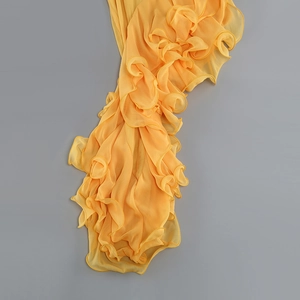 Vue détaillée du tissu en mousseline jaune avec volants plissés et texture transparente