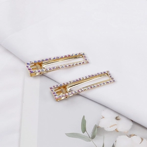 Elegant gold duckbill hair clips with sparkling AB crystals on a clean white background
