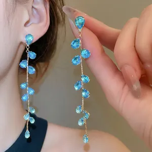 Bohemian gold tassel earrings with teardrop blue crystals and long hanging fringe