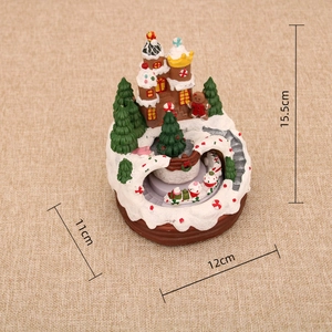 Detailed view of resin Christmas castle with rotating train and dimensions 15.5x12cm