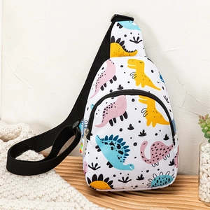White canvas kids dinosaur crossbody chest bag with colorful patterns on a wooden surface