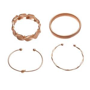 Set of four geometric rose gold metal bracelets featuring twist and knot designs for women