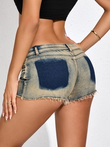 Dettaglio degli shorts in denim con bordi grezzi sfilacciati e lavaggio blu retrò