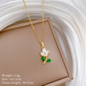 Detail of white flower and green leaf pendant with gold chain and size specifications