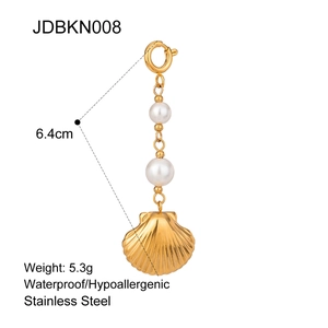 Macro view of gold-plated stainless steel shell and pearl pendant for bikini accessories