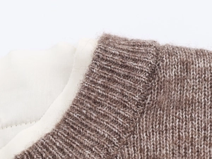 Close-up of knit sweater neck detail featuring fuzzy brown wool and cream lining