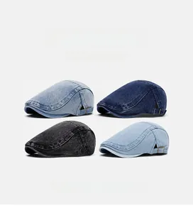 Detail of vintage denim newsboy caps in dark blue, light blue, and grey with metal buckles
