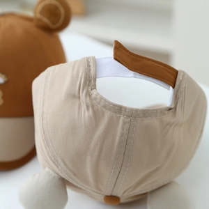 Adjustable beige baby baseball cap with bear ears and velcro strap back view