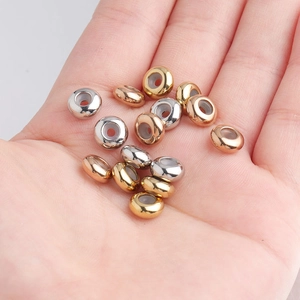 Close-up of 8mm stainless steel positioning beads with silicone core in gold and silver