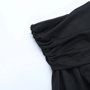 Detail of ruched black knit fabric with elegant mesh stitching and stitching finish